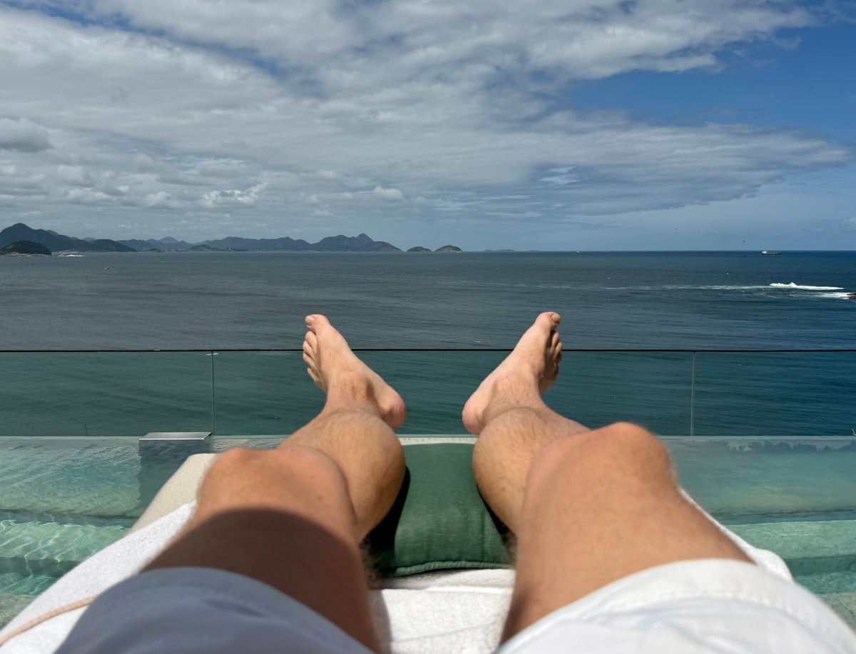 Emiliano Rio sunbathing by rooftop pool