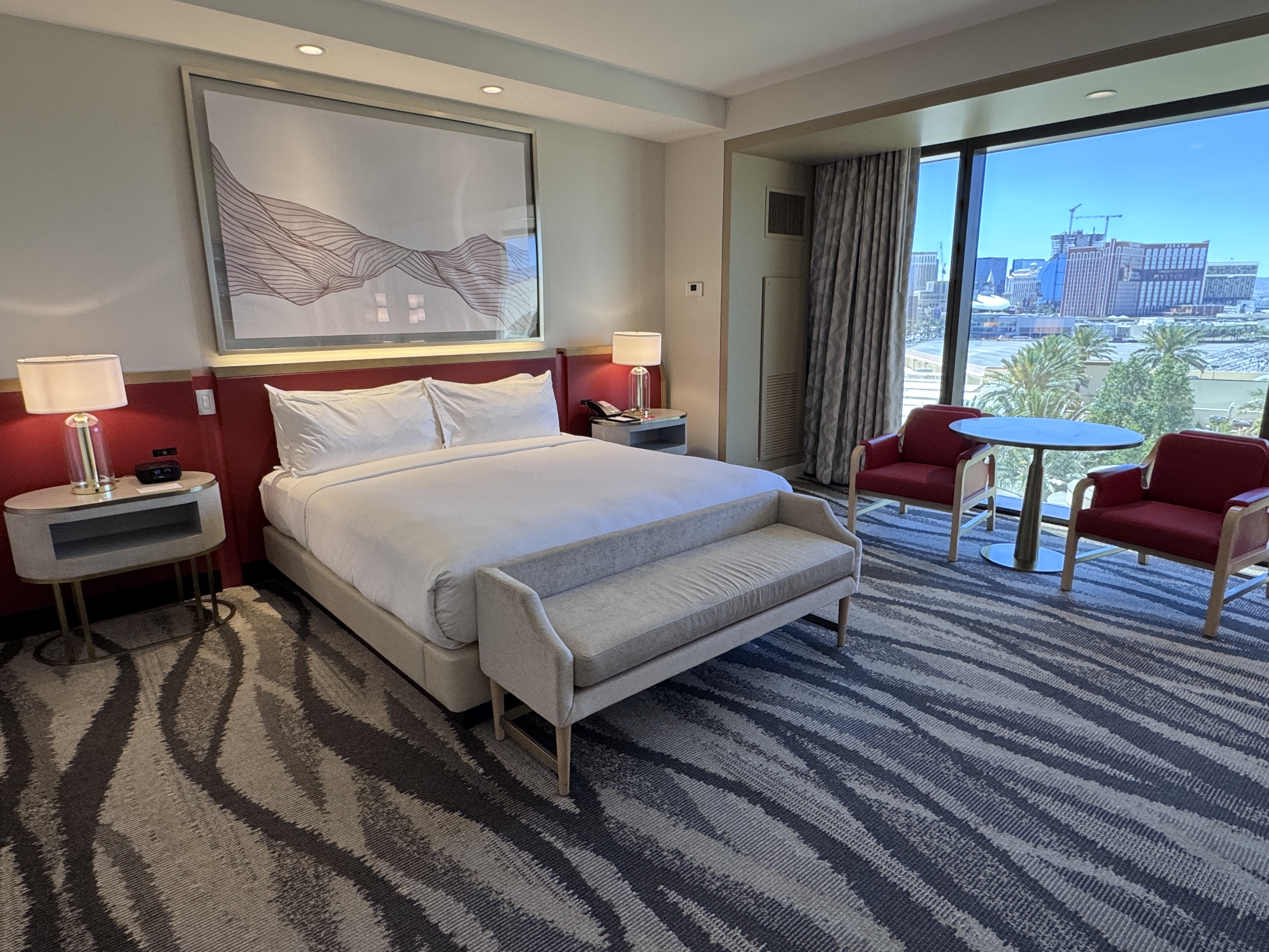 Conrad Las Vegas king room bed with Strip view and seating area