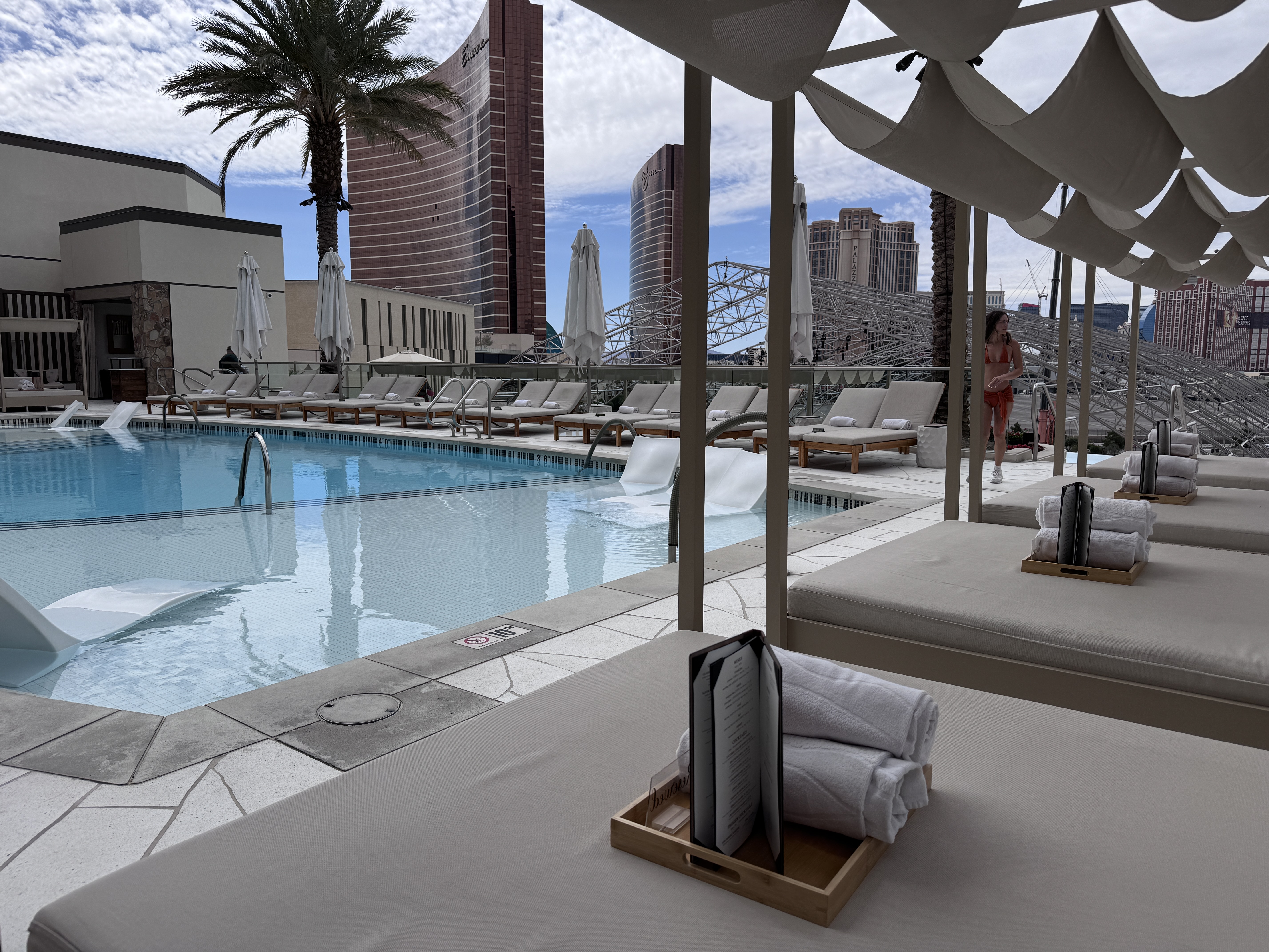 Resorts World Las Vegas Athena Infinity Pool daybed loungers with pool and Strip view