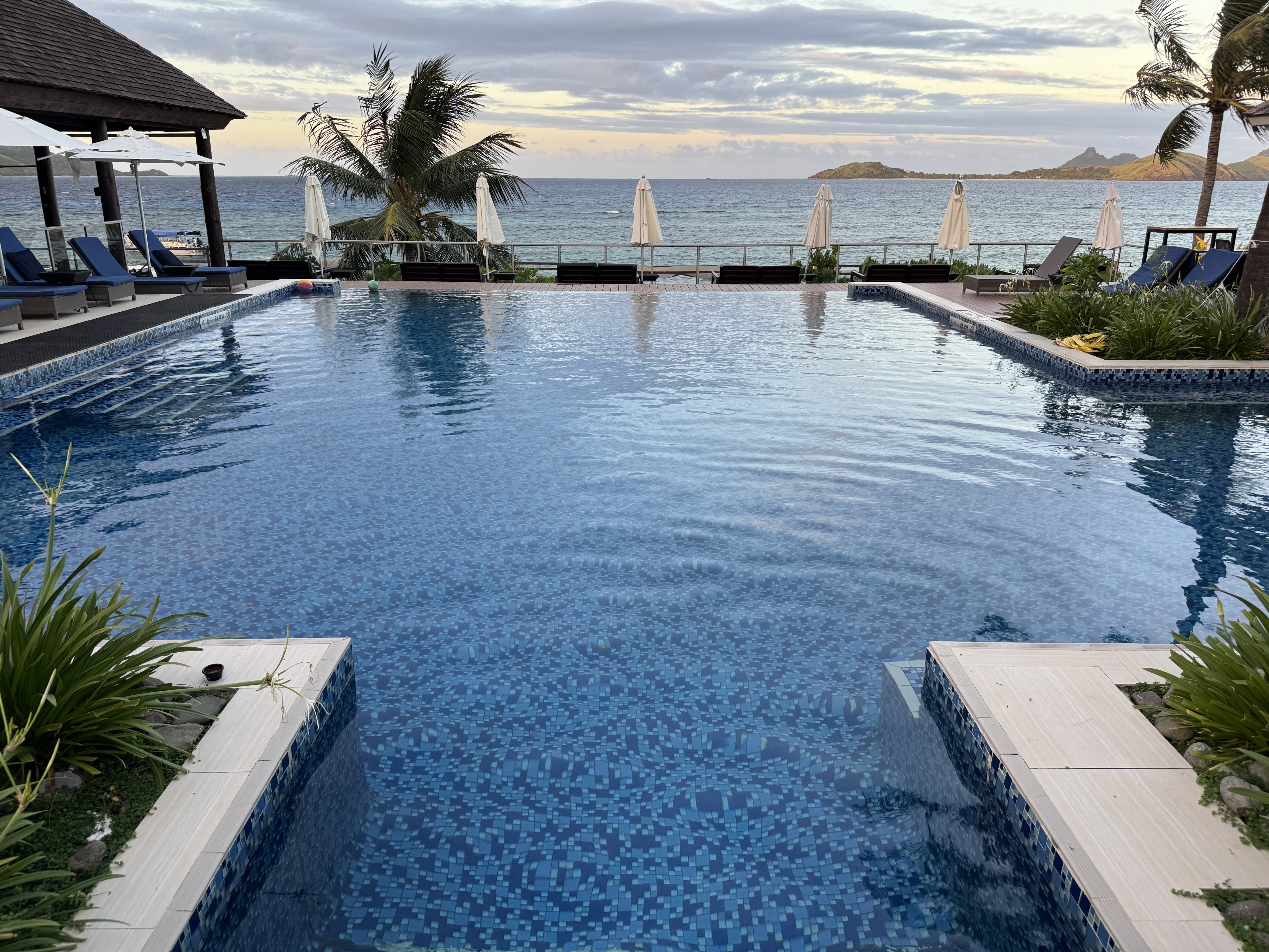 Sheraton Tokoriki Island Infinity pool dusk lounge chairs island views