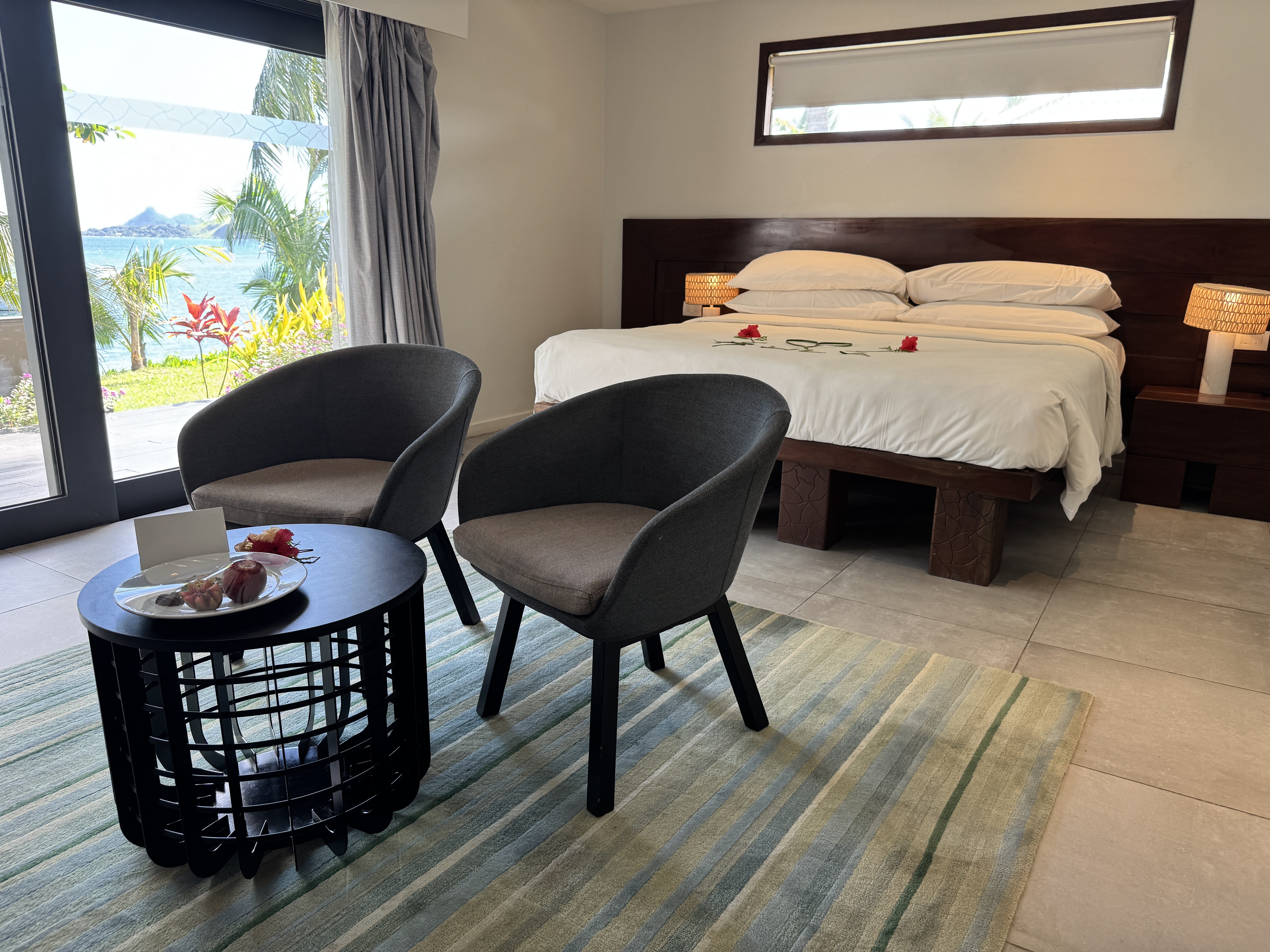 Sheraton Tokoriki Island Ocean view room with king bed decorated with hibiscus flowers