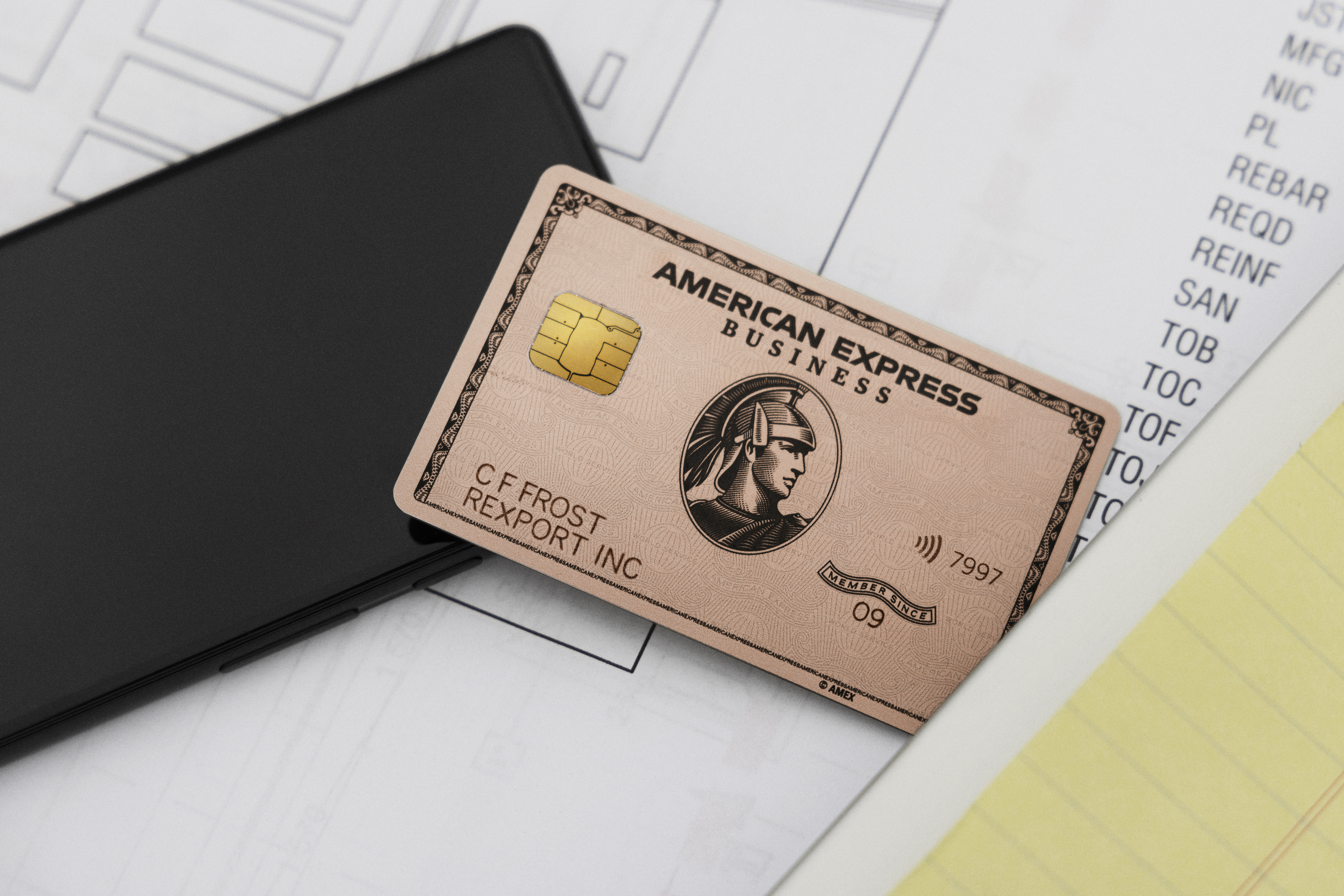 Amex Business Rose Gold Card on top of paperwork