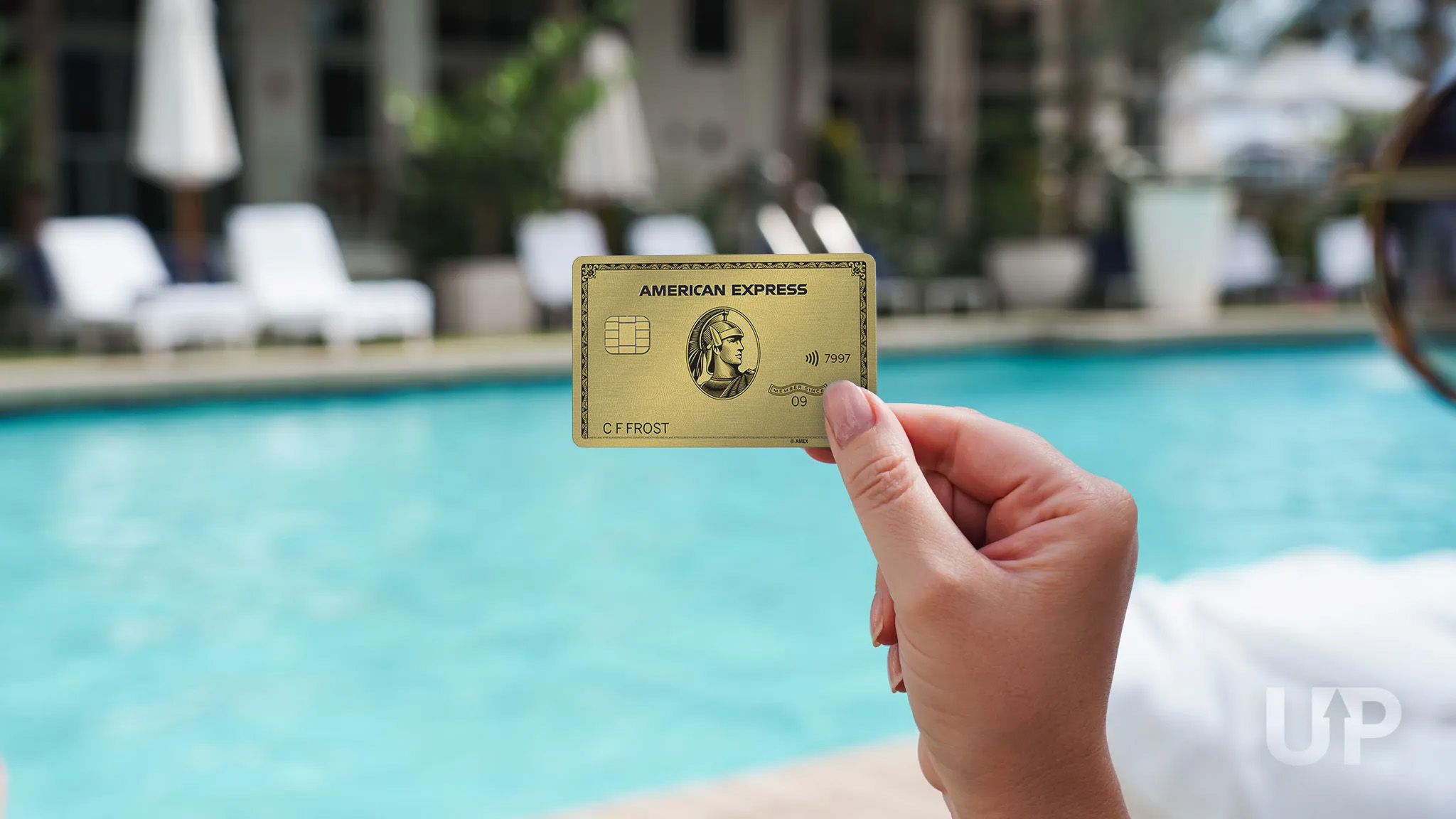 Amex Gold Card in Hand on Pool Deck Upgraded Points LLC Amex Gold Card in Hand on Pool Deck Upgraded Points LLC